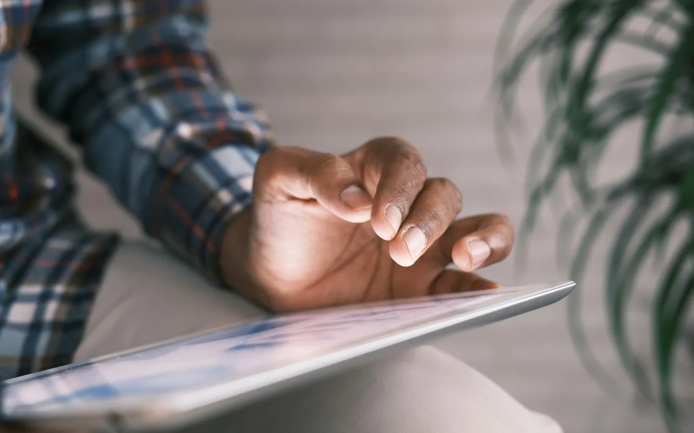 person in blue white and red plaid long sleeve shirt reading book by Towfiqu barbhuiya courtesy of Unsplash.