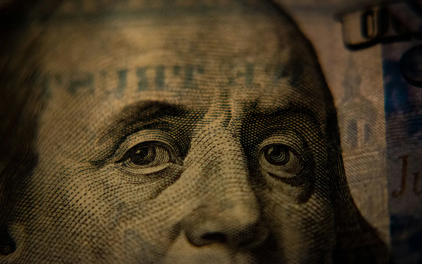 a close up of a one dollar bill by Adam Nir courtesy of Unsplash.