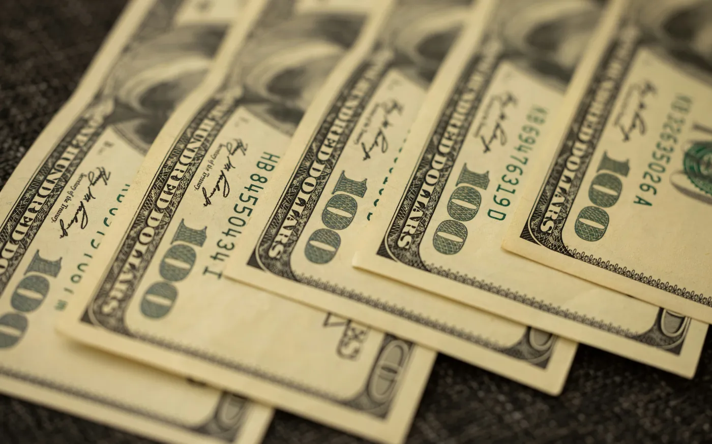 a pile of twenty dollar bills laying on top of each other by engin akyurt courtesy of Unsplash.