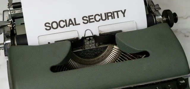 a close up of a typewriter with a paper that says social security by Markus Winkler courtesy of Unsplash.